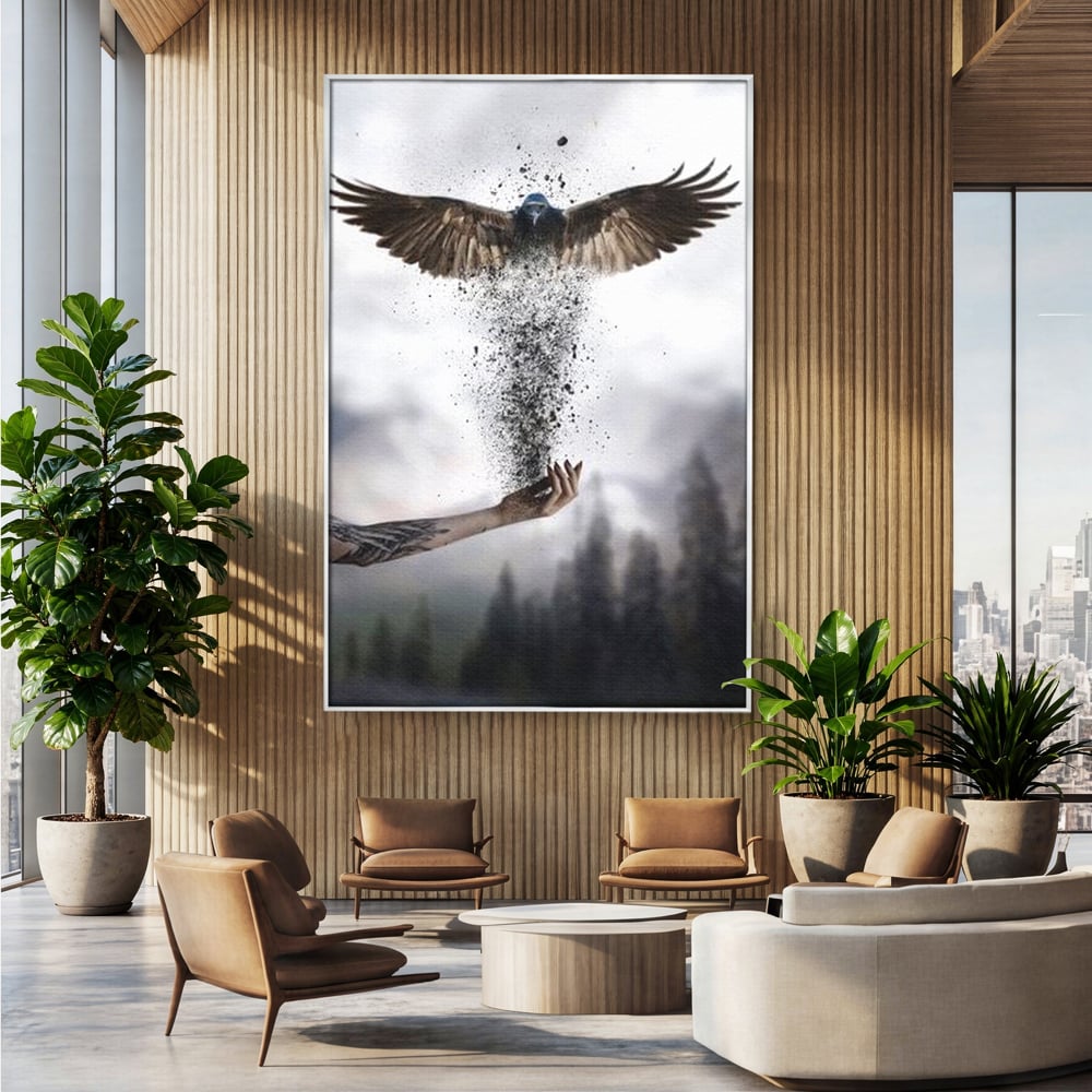 Tablou canvas cu tablou canvas cu pasare si mana din cenusa, in rama de aluminiu argintiu, pe perete intr-un birou